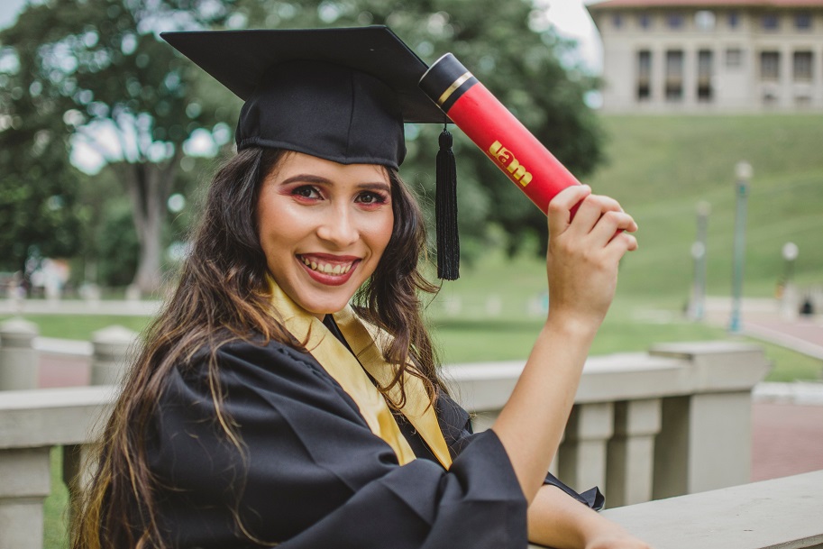 A woman graduate with a diploma