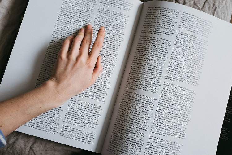 Person reading from large journal